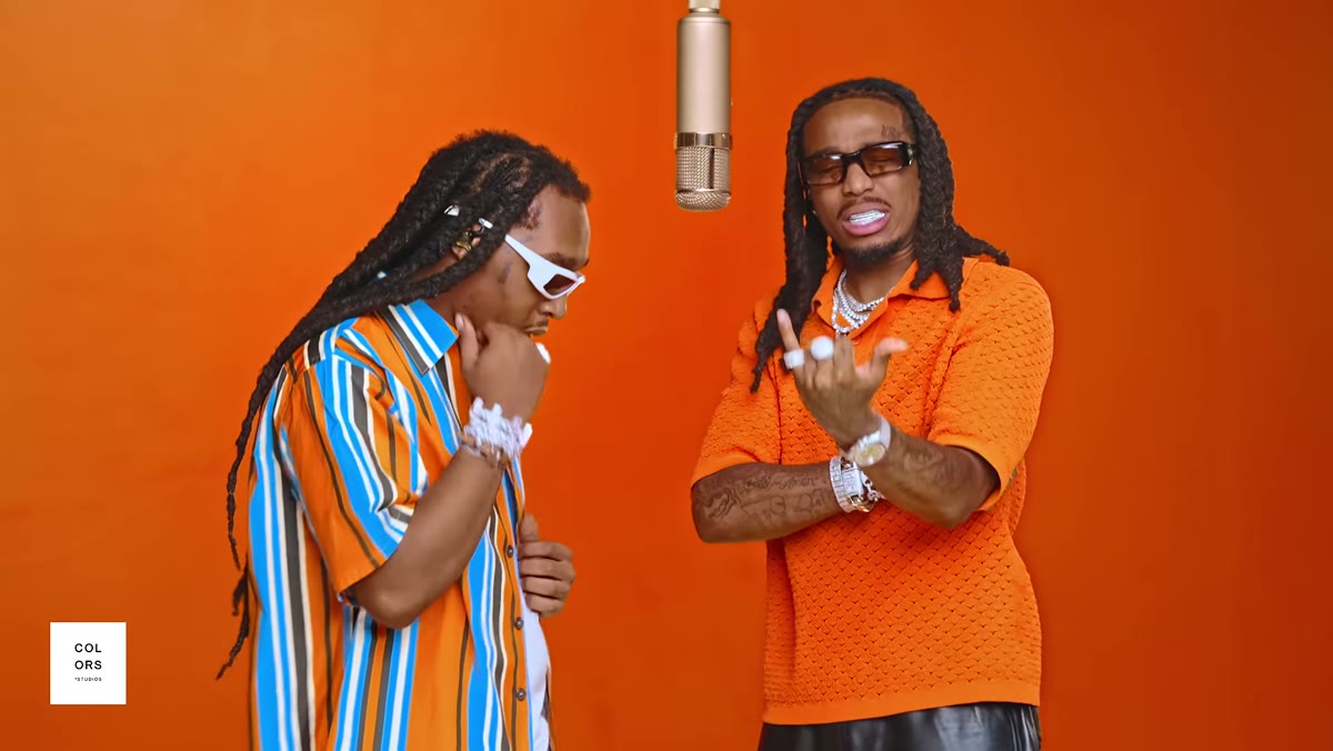 Quavo and Takeoff standing side by side at the microphone in the orange A COLORS SHOW studio during HOTEL LOBBY; the Hotel Lobby AI trend replaces these two performers. Source: COLORS official YouTube (2022)